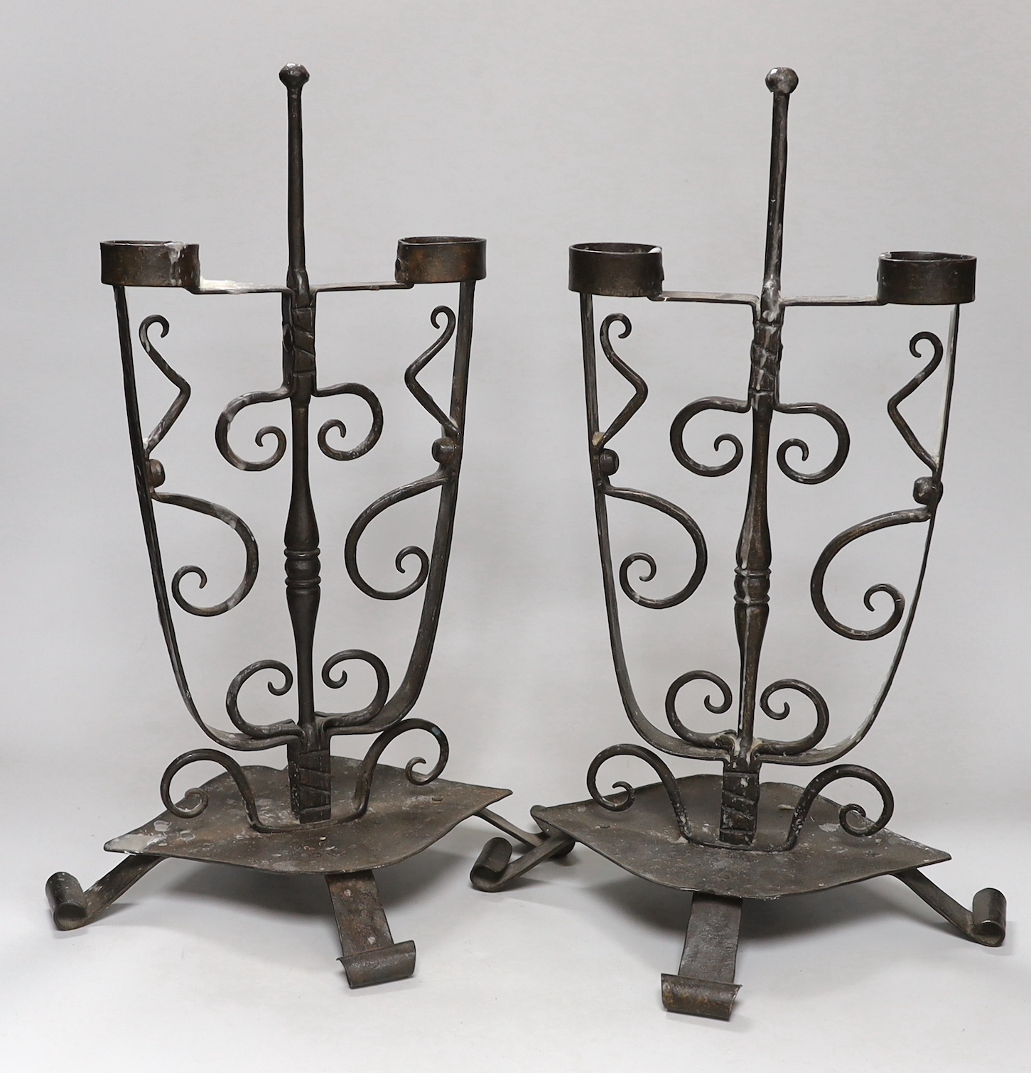 A pair of wrought iron candelabra, height 44.5cm